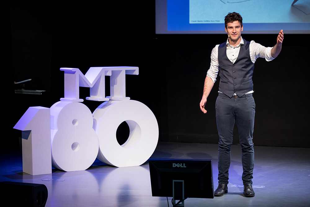 Bastien Marguet speaking on stage during MT180.